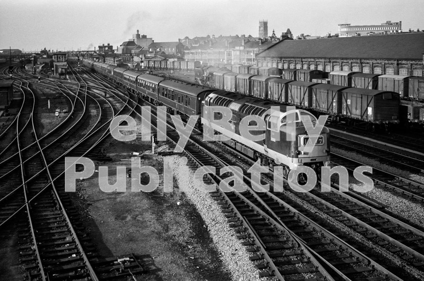 LPIS STM BW NEGS 0129 
 A yet un-named English Electric Deltic D9010 emits the trademark blue exhaust as it accelerates through Doncaster station with the 1A47 13:30 Edinburgh to King's Cross service; the 'Heart of Midlothian' on 8th September 1962. The locomotive was named 'The King's Own Scottish Borderer' on 8th May 1965 at Dumfries, and withdrawn on 24th December 1981.

The summer timetable of 1962, of which September 8th was the last day, saw the introduction of the first timetable when all 22 of the EE Deltics were available to work. Unfortunately, as with many initiatives associated with the Modernisation Plan, the diagrams allowed little time for maintenance, and gradually they were altered to allow locomotives to attain a reasonable level of availability. 
 Keywords: 1962, 64B, BR, Black and White, D9010, Deltic, Diesel, Doncaster, EE, Eastern, Haymarket, Passenger, Yorkshire