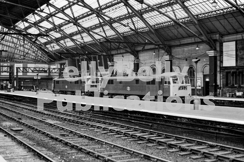 LPPC DSL BW 0384 
 Two AL6 Class 86 electric locos, headed by number E3174 (with E3182 behind), lay-over between the platforms at Liverpool Lime Street station waiting for the next legs in their diagrams in the early 1970s. Still largely in their original conditions with cast numbers and British Rail logos the class maintained all the top-link express services on the LNW routes out of London until the arrival of the Class 87s for the Scottish electrification. E3174 at the front is ready to move forward as soon as its empty-stock arrives to take train 1A52 south as the 14 30 Liverpool Lime Street to London Euston. 
 Keywords: Digital, Rights Managed, Stock