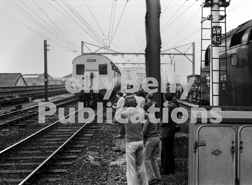 LPPC DSL BW 05270528 
 Trespass? Health and safety? Neither seem to be uppermost in anyones mind at Ashburys station one Saturday in the late 1970s as a large number of the participants of a Class 40 Type 4 number 40170-hauled jaunt around Liverpool, Manchester and the north-west halts for a photo-shop opportunity.
Who could resist a snap of one of the 1500 Volt DC Manchester  Hadfield three car emus as it braked for the station stop on its way to Piccadilly station. 
 Keywords: Digital, Rights Managed, Stock