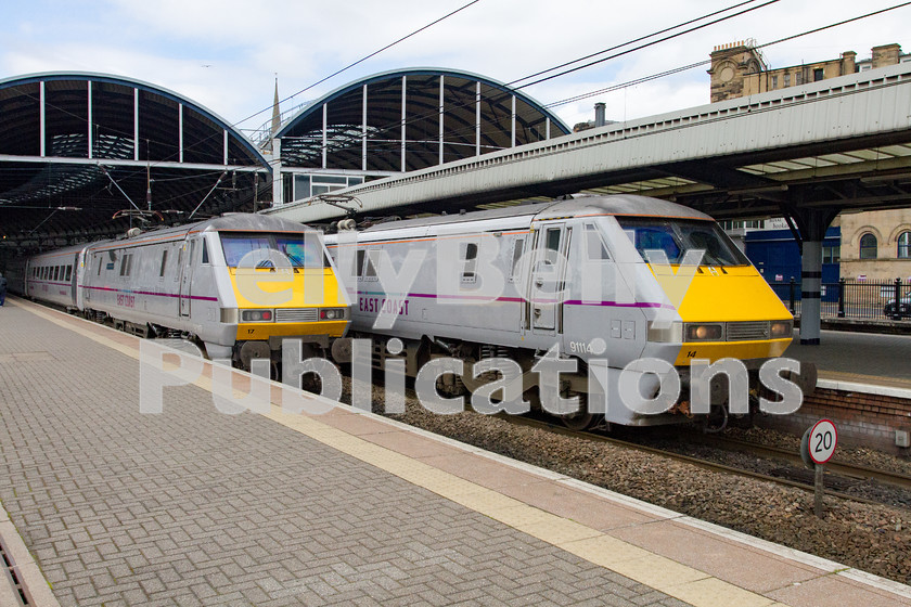 LPIS-D-DSL-CO-0044 
 East Coast Trains Class 91, 91114, waits to depart Newcastle with the slightly delayed 1S07 London King's Cross to Edinburgh service, whilst fellow classmate, 91117, also running slightly late waits to head south with 1S09 from Edinburgh to London King's Cross. 
 Keywords: 1S07, 1S09, 91114, 91117, Class 91, Colour, Digital, East Coast Trains, Eastern, Newcastle, Passenger, Rights Managed, Stock, Tyne and Wear