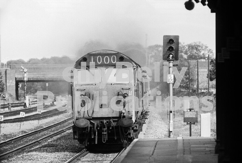 LPPC DSL BW 0892 
 Moving further out of the London area we reach Slough and here on a hot summers day in 1976 an English Electric Class 50 (possibly 50026) thunders west with a down Inter City express for Devon and Cornwall. Nicknamed Hoovers from their engine noise, these locos proved to be worthy replacements of the Western Class 52s. The whole class was turned over to the WR once their original purpose of working north of Crewe on the LMR was no longer required by the electrification of the West Coast main line. I have often wondered if, by the setting of the headcode panel, someone with a sense of humour has unofficially named the loco Western Enterprise.. 
 Keywords: Slough, BR, Western, Class 50, Passenger, 50026