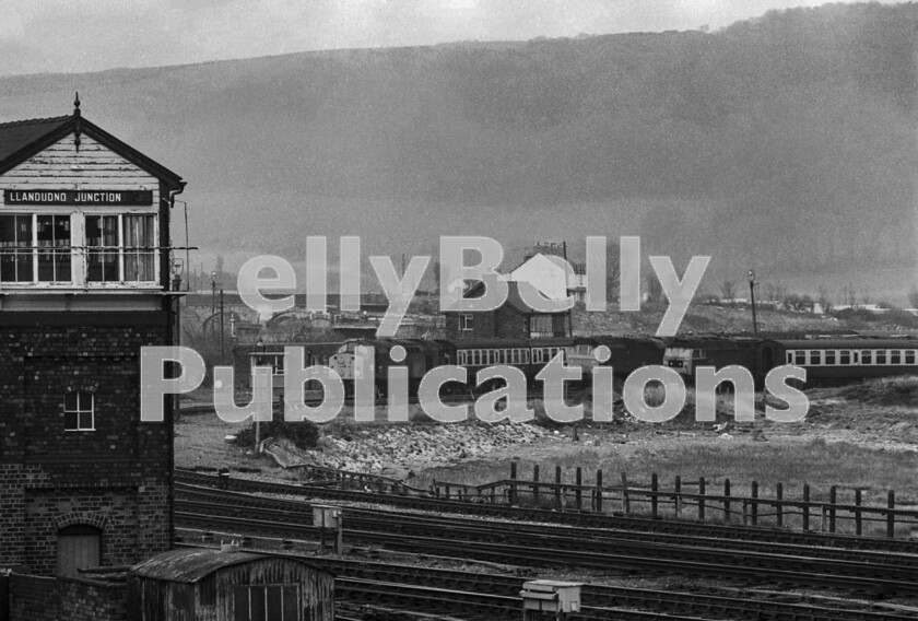 LPPC DSL BW 1164 
 Interlude at Llandudno Junction 5 The prominent LNWR-style signalbox stands guard over the Junction behind which are an assortment of sidings containing empty excursion trains awaiting their time to head to Llandudno town itself to pick up their passengers for their return journeys. They are stabled here due to a lack of siding capacity at the seaside town. Motive power for the trains is a comprehensive selection of locos used by the LMR for these types of trains with, from; left to right, an English Electric Type 4 Class 40, a Sulzer Type 2 Class 25 and a Brush Type 4 Class 47. All of this traffic has now been lost to road. 
 Keywords: Digital, ISO, John Stiles