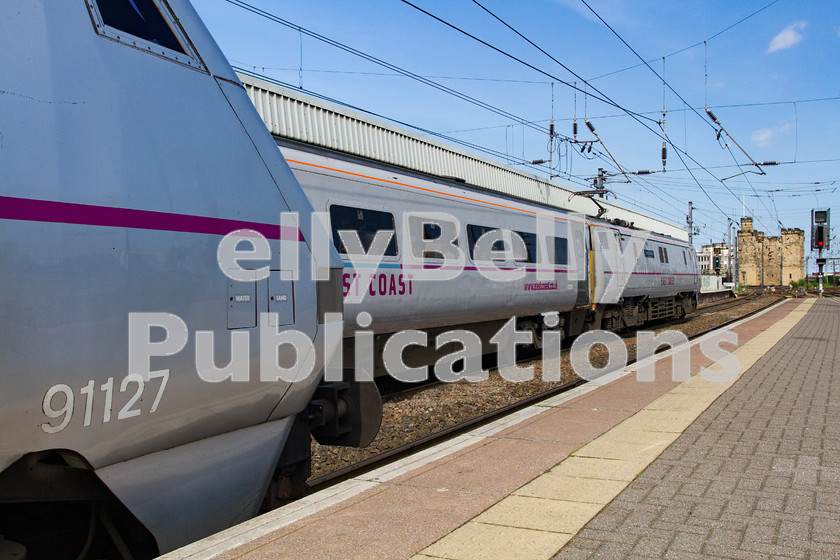 LPIS-D-DSL-CO-0048 
 East Coast Trains Class 91, 91115, waits to depart Newcastle with the 1S18 London King's Cross to Edinburgh service, whilst fellow classmate, 91127 waits to head south with 1E19 from Edinburgh to London King's Cross. 
 Keywords: 1E19, 1S18, 91115, 91127, Class 91, Colour, Digital, East Coast Trains, Eastern, Newcastle, Passenger, Rights Managed, Stock, Tyne and Wear