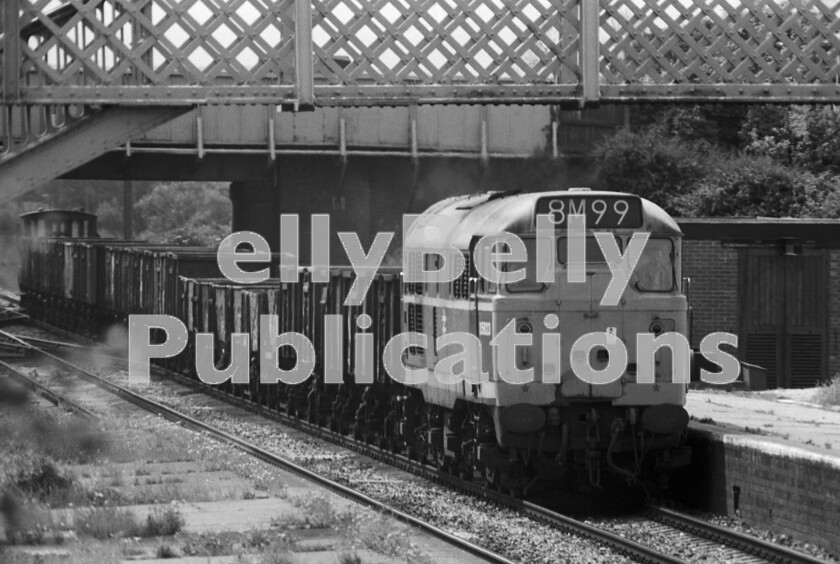 LPPC DSL BW 1127 
 A Brush Type 2 Class 31 number D5823 (later 31291/31456/31556) heads a loose-coupled freight north through Ashchurch. This is exactly the type of traffic of which British Rail was trying obsessively to rid itself of. At the point where the crossover is visible there were originally two converging branch lines. From the left was a loop line from Barnt Green via Evesham and from the right the line from Malvern Wells that came via Upton upon Severn and Tewkesbury. The locomotive appears to have been involved in some sort of front-end collision given the large dent in the right-hand nose door. 
 Keywords: BR, Western, Ashchurch, Freight, 8M99, Collision Damage, D5823, 31291, 31456, 31556, Class 31