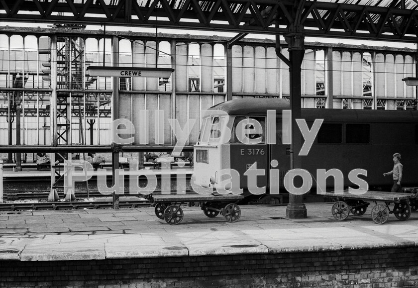 LPPC DSL BW 0429 
 Sunday sequence at Crewe - 1. An interesting mixture of the modern railway of the 1970s with traditional adjuncts as AL6 Class 86 number E3176 arrives from the north at Crewe with a West Coast express while a young spotter hurries down the platform to watch what happens next; whilst all around are period trollies and the flagstones of years past. Note how much parcels traffic was still being conveyed by rail. Were those trollies, made to a very traditional pattern, still being produced and who by? It is possible that this loco still survives as number 86607. 
 Keywords: Digital, Rights Managed, Stock