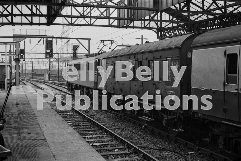 LPPC DSL BW 1240 
 British Rail in transition. The juxtaposition of these items of power and rolling-stock needs little explanation, but the fact remained that whilst BR was happy to keep parcels traffic as a going concern, it probably received scant attention from the accountants in terms of potential future investment. In fact, during the 1970s, as passenger vehicles were being renewed and replaced by then state-of-the-art air-braked and air-conditioned coaches, for the enthusiast, parcels vans of all sorts were a happy hunting ground. About to set off from Crewe up the West Coast main-line  not too quickly one hoped  is a Class 86 fitted eighteen months previously, in December 1971, with a new-style GEC Crossarm Pantograph. The loco is still in service with Freightliner as number 86608 and an LMS-built Stove R van and six-wheeled into the bargain, which is now preserved on the East Lancs Railway! 
 Keywords: Digital, ISO, John Stiles