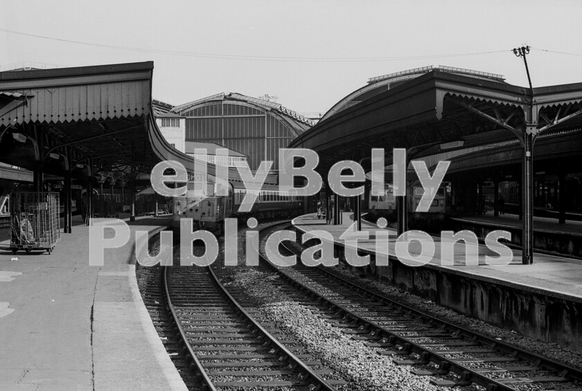 LPPC DSL BW 0263 
 A summers morning at Paddington station in 1971 and on the left one of the newly arrived Brush Type 2 Class 31 locomotives waits to leave for Old Oak Common with 5A71, the empty stock of the 07.58am Didcot service, 1A71, consisting of one of the Western Regions air-braked Mark 2 coaching sets. The Class 47 on Platform 5 is at the head of the 09.45am Paddington to Bristol Temple Meads, 1B52. The DMUs that replaced steam on the Westerns Thames Valley suburban services lasted for many years and one of these units is waiting to leave on Platform 6 with 2A18 from Paddington to Reading at 10.35am, calling at all stations. The Brute trolleys seen on the left of the photograph are left over from the previous nights parcels activities. These trolleys are synonymous with British Rail at this time, and probably burned into the memories of many a rail enthusiast even now, some 50 years later. 
 Keywords: BR, Paddington, Class 31, Class 47, 1971, Passenger