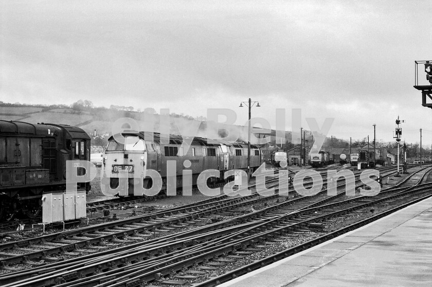 LPPC DSL BW 0635 
 Exeter loco stabling point on a damp Monday morning (we think 26th March 1973) sees the two Western Class 52s (including D1041) seen earlier in typical later-life uncared-for external condition, along with an equally unkempt Class 08 D3797 (later 08630) sharing space with two Sulzer Type 2 Class 25s and a Class 08 waiting for their next duties. Remarkably, there are also a Brush Type 4 Class 47, a Class 35 Hymek, another 08 pilot and a Peak Class 45. One wonders what could have been the traffic requirements for all these locomotives. 
 Keywords: BR, Western, 1973, Exeter St Davids, Shed, depot, Class 08, Class 52, Class 47, Class 45, D3797, 08630,