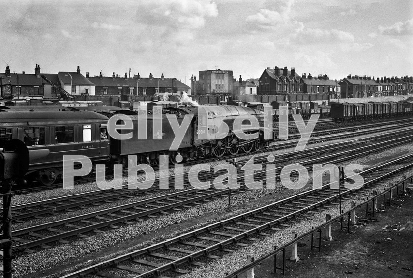 LPIS STM BW NEGS 0128 
 Gresley A4 60010 'Dominion of Canada' acclerates away from Doncaster with 14.10 1E12 Leeds to Kings Cross train sometime in the afternoon/evening. The engine had worked to Leeds with the 1N02 04:00 Kings Cross to Leeds train earlier in the day, but given the chaos surrounding the diversions, its return to London seems to have been delayed. This service was due to be worked by a Finsbury Park Deltic, but given the chaos of the previous 24 hours, the A4 substituted.

The A4 still survives today, having been donated by British Rail in 1966 to the Canadian Railroad Historical Association (CRHA). The locomotive returned home during 2013 as part of the Mallard Festival to mark the 75th Anniversary of the record-breaking run of 4468 "Mallard" on 3rd July 1938. 
 Keywords: 'Dominion of Canada', 10, 1962, 34A, 4489, 60010, A4, BR, Black and White, Doncaster, Eastern, Gresley, King's Cross, LNER, Passenger, Steam, Yorkshire