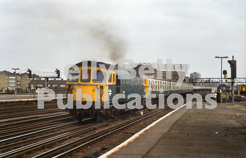 LPAP-DSL-CO-0012 
 Clapham Junction sees 33115 pushing a Waterloo bound service, 12th August 1983. 
 Keywords: BR, Southern, Southern, London, Clapham Junction, Diesel, BR, Passenger, Colour, Class33, 33115, D6533, EH, 71A, 1983