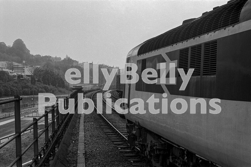 LPPC DSL BW 0481 
 The prototype train for the immensely successful HST project, originally Class 41, was extensively tested, first on the Eastern Region and later, in revenue service, on the Western Region. Here it is in the Summer of 1975 about to leave Bath Spa on its daytime diagram down leg to Bristol, as a Cardiff-Portsmouth service pulls into the up platform conveying a GUV in its consist. 
 Keywords: BR, Western, HST, Prototype, Class 41, GUC, Bath, Passenger