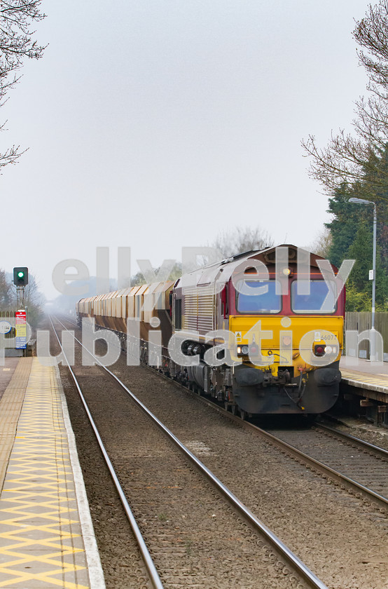 LPIS-D-DSL-CO-0019 
 EWS/DB Schenker Class 66, 66077, passes through Thurston station heading towards Barham with the 6L41 Mountsorrel to Barham mineral train on 2nd April 2014. 
 Keywords: 66077, Bury St. Edmunds, Class 66, Colour, DB Schenker, Digital, EWS, East Anglia, Eastern, Freight, Minerals, Rights Managed, Stock, Suffolk