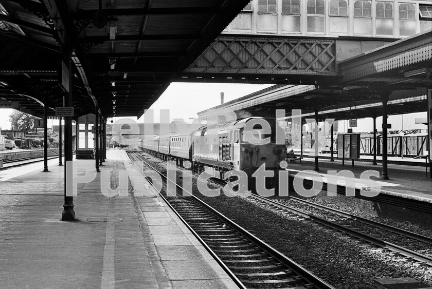 LPPC DSL BW 0893 
 A quiet weekday afternoon in 1976 on the down main platform as a Class 50 heads London-bound through Slough on a set of Mark 2As and 2Bs. It is throbbing loudly at around 90mph as the driver applies power to maintain the momentum. Amazingly, into the third decade of BR, the station still has work for a Class 08 350hp shunter as pilot. 
 Keywords: BR, Slough, Class 50, BR, Western, Class 08, Freight, Passenger