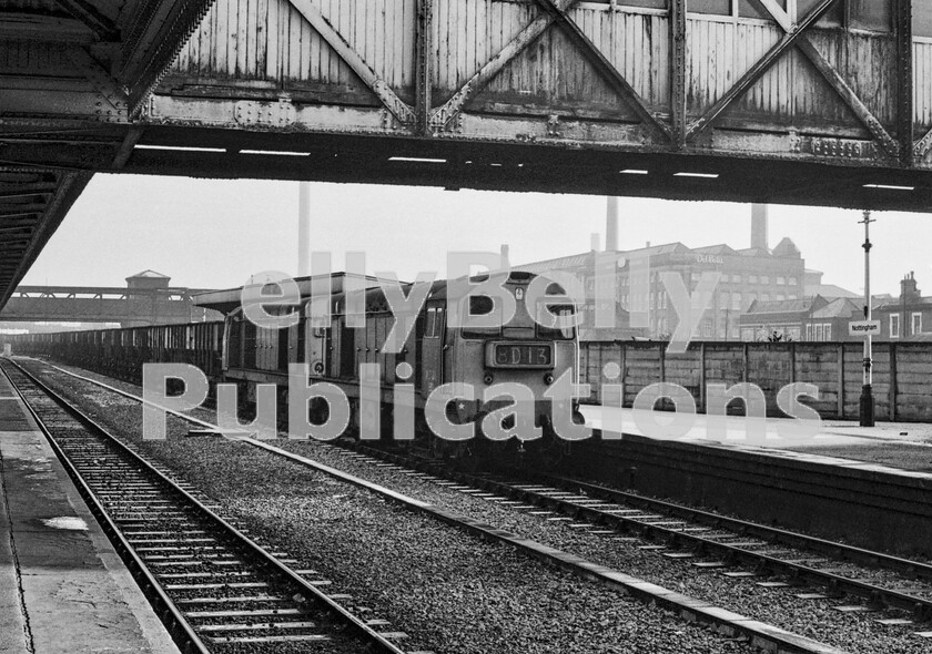 LPPC DSL BW 0824 
 An extremely lengthy unfitted train of empty coal hoppers inches its way alongside a platform at Nottingham station trying not to stop completely and so avoid the wagons buffering-up. It is heading west, taking the empties back to the Midlands coal-fields to be loaded up and go through the east then west process again. Class 20s in multiple were very popular on these trains, allocated to Toton depot they were the ultimate load-luggers for the Division. Note that the station name is simply Nottingham as it had previously had the description Midland added to the name when the, by then totally closed, Great Central Victoria station was operating. The train itself is actually a timetabled daily working, 8D13, the MSX 10 50 Staythorpe CEGB Power Station near Newark to Newstead Colliery Sidings which were near Annesley on a remaining stub of the old Great Central main line.