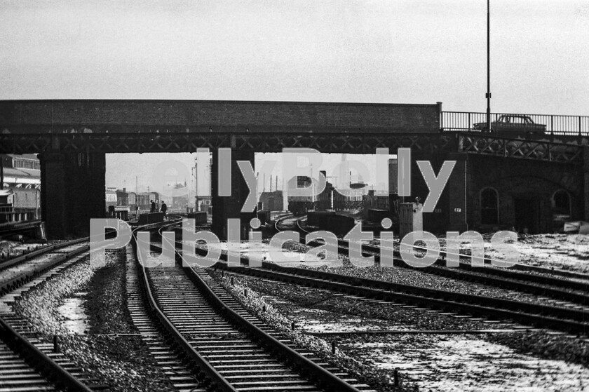 LPPC DSL BW 0823 
 Our Christmas & New Year visit to Nottingham and Toton 1971 produced this view immediately after alighting from our train from St Pancras. It was cold and bleak looking east from Nottingham Midland station towards the Parcels Concentraion Depot on the left, and the freight yard to the right. The Sulzer Type 2 Class 25 was beginning to move with its motley collection of freight wagons from the yards in the direction of Colwick, no longer in constant use with coal traffic. Note the Singer Vogue about to cross the bridge above. 
 Keywords: Digital, Rights Managed, Stock