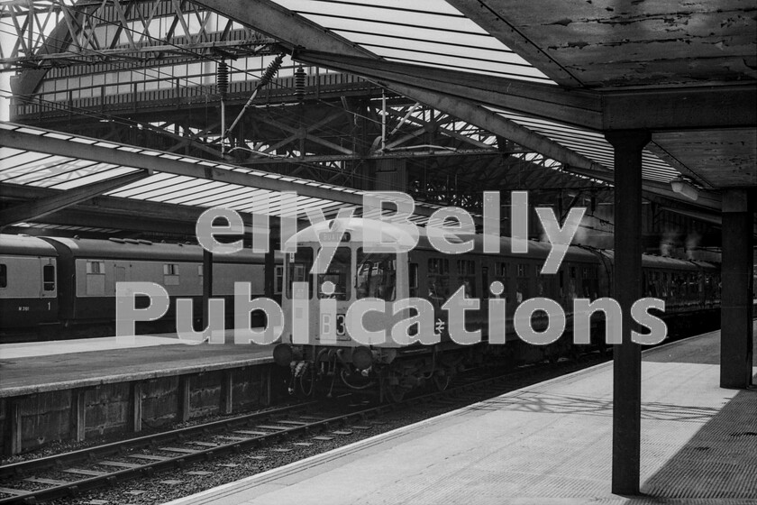 LPPC DSL BW 0382 
 Its a late summer weekday at Manchester Piccadilly station in the early 70s and a DMU consist awaits departure for Buxton. There were many different classes of diesel unit on British Rail and this is a member of TOPS Class 104, built by the Birmingham Railway Carriage and Wagon company. This was a Longsight allocated unit and the depot has applied some white paint to the top of this driving car end to create a custom look in much the same way as the Eastern Regions Stratford depot was doing with its Brush Type 4 locomotives. Note that in the background an Inter-City service for London Euston has a Mark One Kitchen/Restaurant car, despite the rest of the stock being Mark 2D/F. Catering vehicles were never built to the specification of Mark 2 coaches; presumably, the budget didnt stretch that far.