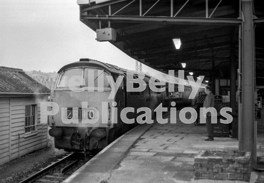 LPPC DSL BW 0575 
 Early on a cold April Saturday morning in 1974 at Plymouth North Road station the first semi-fast of the day prepares to set off for Penzance conveying passengers from the nights sleeper from Paddington who didnt want to be decanted at stops like Liskeard before it was light, as it was possible to sleep a little longer in the car that was detached here. By this time the numbers of Western Class 52s were dwindling rapidly, but this one (D1025 Western Guardsman) being inspected by my father seemed to be very sound with its steam-heat boiler in full working order  essential as it was before 07.00am and a raw day was in prospect. This ex GWR station, completely rebuilt in the 1960s, was called North Road to distinguish it from the Southerns Friary terminus, but since the closure of the latter the suffix was dropped, leaving it simply as Plymouth. 
 Keywords: BR, Western, Plymouth, Class 52, Western, D1025, 'Western Guardsman', Passenger