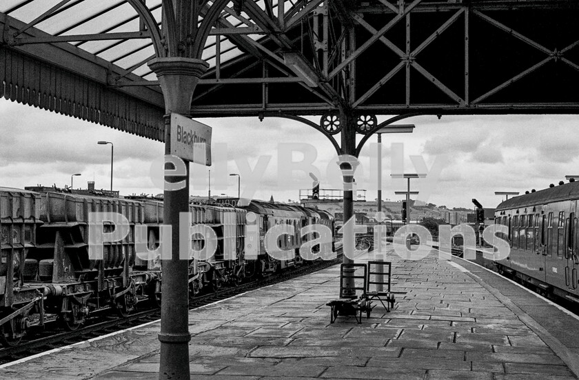 LPPC DSL BW 0561 
 A busy moment at Blackburn station one summers morning as two Sulzer Type 2 Class 25s clank to a stop with possibly number 5157 being the nearest loco. They are heading a block train of cement from Horrocksford Works towards Preston. Approaching in the right background is a two-car Cravens DMU working a Preston to Colne stopping service whilst the Derby-built two-car on the right is waiting time until departing on an all-stations trip to Bolton and possibly beyond to Manchester Victoria. 
 Keywords: Digital, Rights Managed, Stock