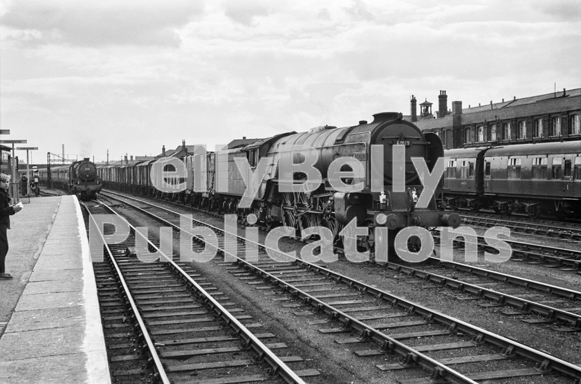 LPIS STM BW NEGS 0121 
 Peppercorn A1 60119 'Patrick Stirling' slowly makes its way through Doncaster on the Down Goods line with the 4S04 14:15 Ferme Park to Millerhill freight on 8th September 1962., as an unidentified Thompson B1 approaches with a Down express.

60119 had replaced another engine in Doncaster Decoy sidings and would be replaced itself in Newcastle. The locomotive was condemned at Doncaster Carr shed on 31st May 1964.

By September 1962 the use of pacifics on freights was commonplace, despite the fact that the engine was only 14 years old when the photograph was taken. 
 Keywords: 'Patrick Stirling', 1962, 36A, 4S04, 60119, A1, BR, Black and White, Doncaster, Eastern, Freight, LNER, Peppercorn, Steam, Yorkshire