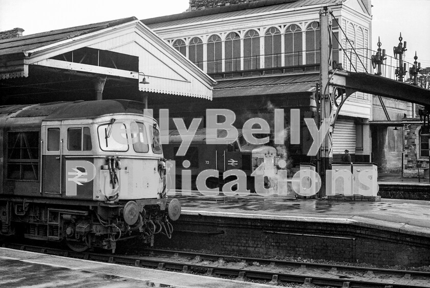 LPPC DSL BW 0634 
 Exeter St Davids in the early 1970s and a wet Saturday morning witnesses a Southern Region Crompton Class 33 Type 3 adjacent to Peak Class 45 number 72 (later 45050). The former has arrived from London Waterloo via Salisbury and the South Western main line and has just run around its train and reattached ready for the return run to the metropolis. The Peak is at the head of the 1V72 Bradford to Penzance North and West express, or Cross Country as it is now described, having reached Exeter via the Midlands Derby to Bristol main line and the Lickey Incline. 
 Keywords: BR, Western, Class 33, Class 45, Exeter St Davids, Passenger, 72, 45050, 1V72