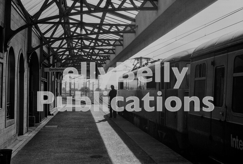 LPPC DSL BW 0675 
 A bright and cool morning at Carstairs station as a Glasgow to Birmingham train, headed by an AL6 Class 86 electric stands and waits for the connecting service from Edindurgh which will soon arrive from the mid-left of the picture. These trains, consisting of three or four coaches arrived on the left, down, platform and after passenger and station work drew forward towards Glasgow before reversing over to shunt onto the back of the ex-Glasgow portion with no requirement for the passengers to alight at all. Imagine that today.