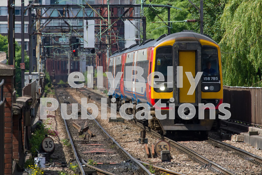 LPIS-D-DSL-CO-0031 
 East Midlands Trains Class 158, 158785, leads 1L09 from Liverpool Street to Norwich as it approaches Manchester Piccadily station on 12th June 2014. 
 Keywords: 158 785, Class 158, Colour, Digital, East Midlands Trains, Greater Manchester, Manchester Piccadily, Midland, Passenger, Rights Managed, Stock