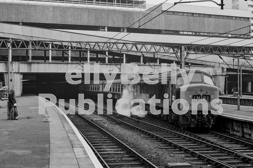 LPPC DSL BW 0478 
 There is a delicious irony here in this Sunday shot at Birmingham New Street station as a North East/South West train rests after arrival on an autumn afternoon 1974. What was a delightful, cavernous, dark and, perhaps, dingy Victorian station has been replaced with a soulless, morale-sapping, cavernous, dark and dingy brutalist structure from which has emerged Peak Class 45 number 45009 terminating the Sundays only 09.55 from Leeds. The brave, new, white-hot heat of the technological revolution represented by the station and the overhead electrical paraphernalia is rather marred by the large cloud of train-heating steam issuing from a leaking Mark One coach pipe connection. One assumes that the lone figure on the platform is waiting for a train. The final word on New Street is that its top floor has already outlived its usefulness and been converted into a massive food and retail area. Why run comfortable and popular, staffed, buffet and restaurant cars in trains when revenue can be generated by passengers spending money at stations purchasing carry-out refreshments? 
 Keywords: Digital, Rights Managed, Stock