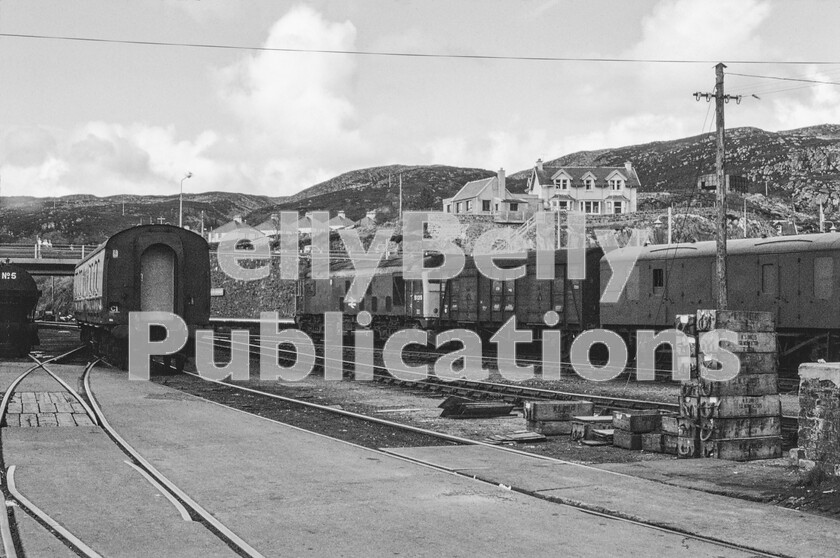 LPPC DSL CO 004900610080-Edit 
 Waiting at the opposite platform face to that depicted on Page 174 is the afternoon Kyle to Inverness service train which our railtour was due to follow down the single line. Headed by one of Inverness (60A) depots ubiquitous Sulzer Type 2 Class 24s number 5125 it has the rugged coastline on the edge of Loch Carron and part of Kyle town as a backdrop. On the right are some fish boxes stacked which used to give the Guards Vans on these trains their unique aroma. When the Southern CCT behind the loco was built it probably never expected to end up so far from home in the course of its duties. 
 Keywords: Digital, Rights Managed, Stock