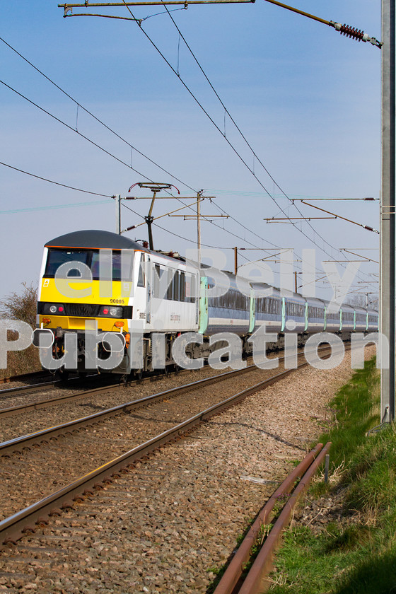 LPIS-D-DSL-CO-0010 
 Sporting the latest Abellio Greater Anglia livery, Class 90 90005 pushes 1P18 London Liverpool Street to Norwich past Wassicks Lane level crossing on 13th March 2014. 
 Keywords: 90005, Abellio, Class90, Colour, Digital, East Anglia, Eastern, Greater Anglia, Haughley Junction, Passenger, Rights Managed, Stock, Suffolk, Wassicks Lane Level Crossing