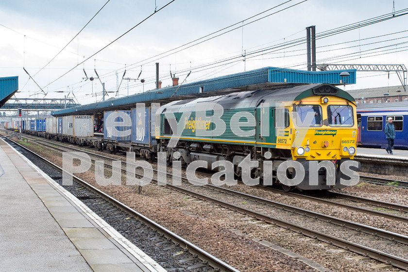 LPIS-D-DSL-CO-0022 
 Freightliner Class 66, 66572, gathers pace through Doncaster station with 4E22 Felixstowe to Leeds container train on 5th April 2014. 
 Keywords: 66572, Class 66, Colour, Container, Digital, Doncaster, Eastern, Freight, Freightliner, Rights Managed, Stock, Yorkshire