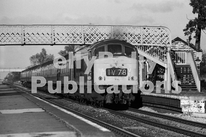 LPPC DSL BW 0877 
 Heading north from Gloucester towards the Lickey Incline the line passes through Cheltenham and soon reaches Ashchurch, which once boasted a triangular junction and platforms as well as a rail flat crossing. On an autumnal Saturday afternoon, a Peak Class 46 thunders at over 90mph through the then-closed station with a southbound North and West Route express. The station closed in November 1971, but has since reopened to serve nearby Tewkesbury. 
 Keywords: BR, Ashchurch, Western, Class 46, Peak, Passenger, Disused