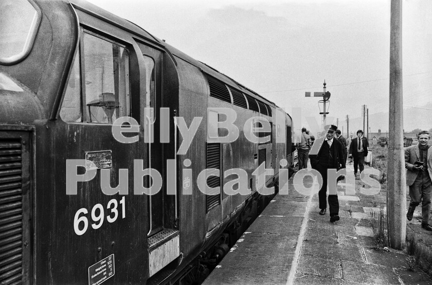 LPPC DSL BW 0221 
 Craven Arms in the Welsh Marches on a Saturday 5th June 1971. The RCTS The Heart of Wales Rail Tour ran on 5th June 197l is waiting for the right-away before heading right onto the Central Wales line, with Barry Docks being its next goal so that the participants can spend time exploring Woodhams scrapyard and all the derelict steam locos stabled there. 6931 is a Class 37 English Electric Type 3 (later 37231/37896) and one of a large number allocated to South Wales at the time. This ones home depot is Landore as can be seen by the code on the bodyside sticker. The train had started from London Kensington Olympia and travelled by means of the Great Western South Wales main line as far as Maindee Junction at Newport, where the EE Type 3 was waiting. It then turned north up the Western Region North and West route via Hereford to Craven Arms. The Class 47 (1675 Amazon - later 47089) that brought the train from London ran light to Cardiff Canton for servicing whilst 6931 attached to the stock and was here forced to make a reversing move to gain access to the Central Wales line. 
 Keywords: BR, Western, Wales, Railtour, 6931, Craven Arms, 1971, 'The Heart of Wales Rail Tour', RCTS, Passenger