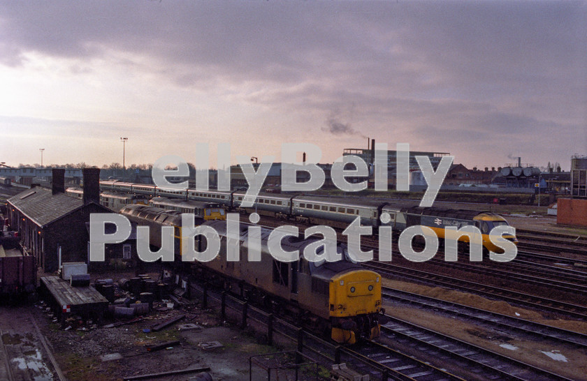 LPAP-DSL-CO-0105 
 An HST heads passed Peterborough depot, the line up headed by 37199, 26th January 1985. 
 Keywords: BR, Eastern, LNER, Cambridgeshire, Peterborough, Diesel, BR, Shed, Colour, Class37, 37199, D6899, GD, 1985