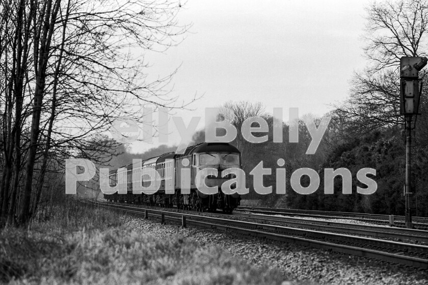 LPPC DSL BW 0443 
 Powering out of Sonning Cutting towards Twyford is a Brush Type 4 Class 47 on the 08.25am 1V18 from Birmingham to Paddington train on a Saturday morning in the 1970s. The train is entirely of Mark 1 stock and probably consists of carriages then intended for weekday Thames Valley peak-hour commuter services. Although these sets spent most daytimes in OOC sidings before returning home with their commuters, the Coaching Stock section made much use of them at weekends allocating them on anything from Footexs to Merrymakers. Few of those joining these carriages at, say, Didcot on a Monday morning would have realised that they had been to Blackpool, Margate, Tenby or York the day before. 
 Keywords: BR, Western, Class 47, Sonning Cutting, Passenger