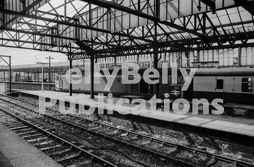 LPPC DSL BW 0364 
 Light and shade at Crewe as Class 50 number 432 draws to a stand with a southbound express in Summer 73, later nicknamed Hoovers because of the noise all their auxiliaries created, they were large locomotives but were a considerable improvement over the mediocre performance of a Class 40. Yet more of those early-style trolleys lie around on the platform and could have been at Crewe since the filming of the classic film Night Mail. 
 Keywords: Digital, Rights Managed, Stock