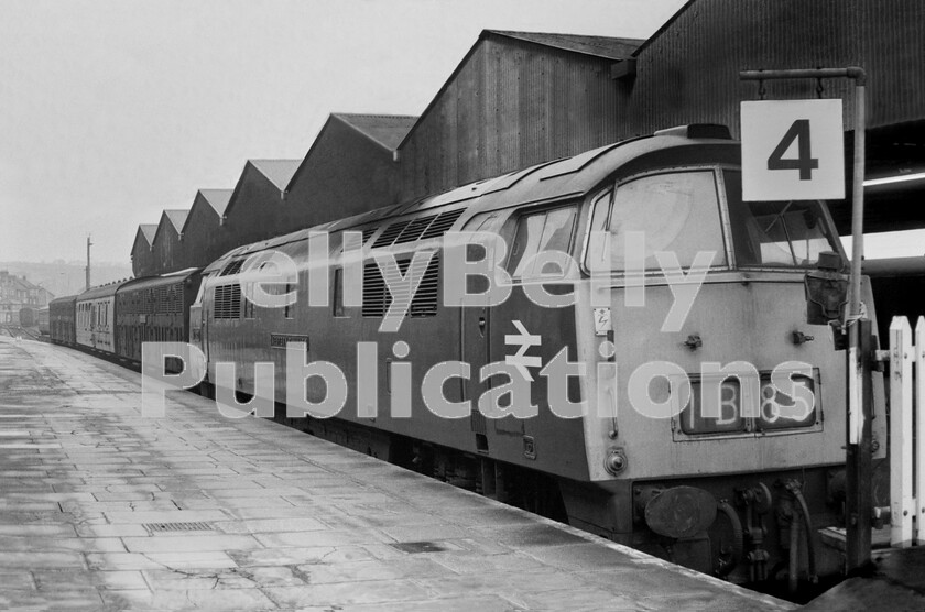 LPPC DSL BW 0486 
 The train parked here in number 4 platform at Penzance is perhaps more interesting than the Western Class 52 D1021 Western Cavalier at its head. It consists of two ex-Great Western Siphon G bogie-vans affixed with Enparts identification plates and they bookend a Mark 1 Corridor Brake, all allocated to the motive power department. The train is either waiting to back down to Long Rock motive power depot to deliver/pick-up locomotive spare parts, or has finished its business there and is awaiting a suitable empty-stock and/or parcels train to which it can be attached for return to its home depot which could be Laira, Bristol Bath Road, Old Oak Common, or possibly even Swindon Works. 
 Keywords: BR, Western, Parcels, Penzance, Class 52, D1021, 'Western Cavalier', Siphon G, 1974