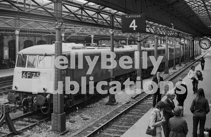 LPPC DSL BW 1239 
 As we have seen, until the completion of the WCML electrification throughout from London to Glasgow all trains changed from diesel power to electric or vice versa at Crewe and this is a view of the southbound locomotive siding for engines awaiting the arrival of any diesel-hauled trains from the north or from the Chester line. They consist of a pioneer Class 81 still with its smart cast numbers E3013 and later to become 81011, followed by three Class 86s, two of which are E3140, later 86046/86258/86501 and E3145, later 86014/86414/86614. The passengers, not customers, milling around on the platform are waiting for a train from Barrow-in-Furness to take them on to London. 
 Keywords: Digital, ISO, John Stiles