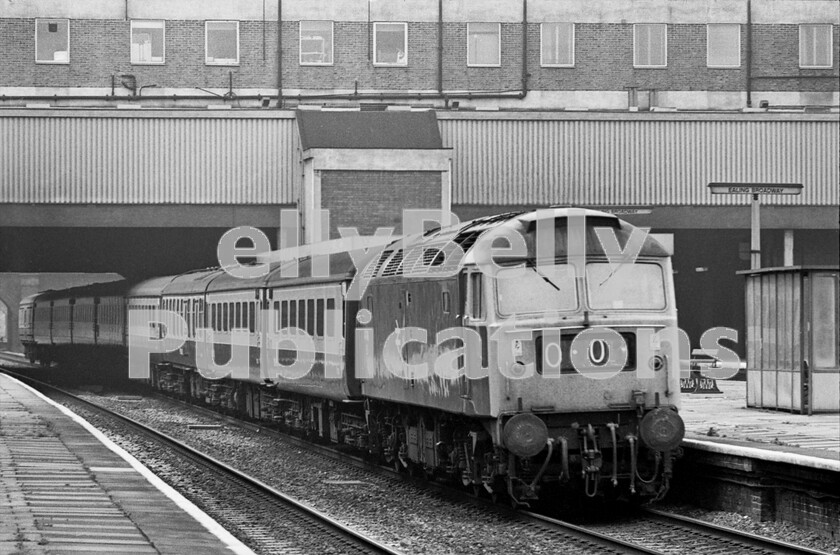 LPPC DSL BW 0407 
 A Brush Type 4 Class 47 races through, unappealing except for the solitary GWR seat, Ealing Broadway station on its way to Paddington with a typical Western Region express consisting of seven Mark 2Ds/Fs with a Mark 1 Full Brake  BG  and a Mark 1 RB - Restaurant Buffet. Organising the allocations of the RBs was particularly difficult as there werent many and the requirements for service, deep-cleaning, specials and weekend working left little or no leeway for the Stock Controllers at Paddington. After a lot of help from the Unidentified Class 47 Group on FaceBook, the locomotive has been identified as 47498, and the train is a Swansea to London service in the Summer of 1976... who needs notes? 
 Keywords: BR, Western, Ealing Broadway, Passenger, Class 47, 1976, 47498