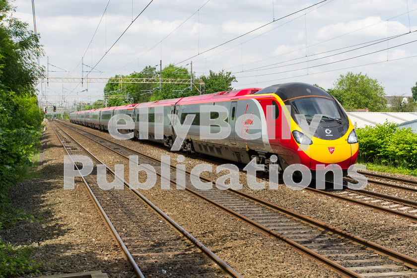 LPIS-D-DSL-CO-0034 
 Virgin Trains West Coast Pendolino, 390 156, racers through Heaton Chapel on 12th June 2014 with 1A41 the 13:55 service from Manchester Piccadily to London Euston. 
 Keywords: 390 156, Class 390, Colour, Digital, Greater Manchester, Heaton Chapel, Midland, Passenger, Pendolino, Rights Managed, Stock, Virgin Trains West Coast