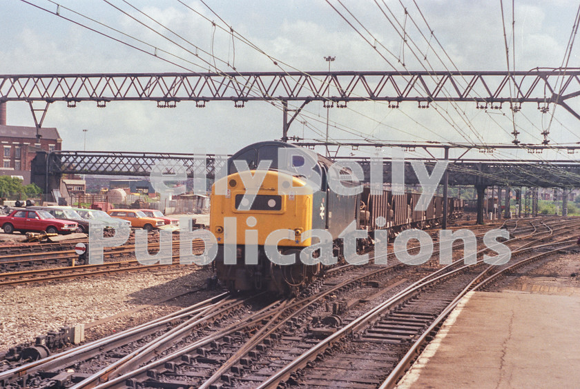 LPAP-DSL-CO-0012 
 Through the now lifted track at the back of Guide Bridge station, 40181 leads a ballast, heading west, 31st May 1983. 
 Keywords: BR, Midland, LMS, Manchester, Guide Bridge, Diesel, BR, Engineer, Colour, Class40, 40181, D381, SP, 1983