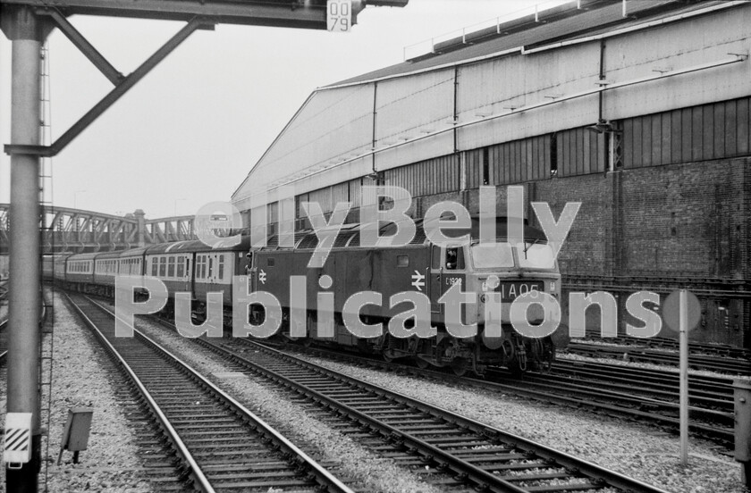 LPPC DSL BW 0289 
 This photograph is not all it seems. The 11.55am Paignton to Paddington Express, 1A05, due in Platform 2 at 15.50pm, seems to have been late into London behind Brush Type 4 Class 47 number D1932 (later 47493/47701). The photograph was taken pre-May 1972, when the loco had its boiler removed and was fitted with Electric Train Heating (ETH). The train would form the 16.30pm service to Penzance, nominally from Platform 2, and so as to reduce any delays and platform changes, it seems that the train is being dragged out of Paddington and re-positioned to Platform 2 for departure. The train is a standard air-braked set of Mark 2 coaches with a Mark 2A BFK behind the loco. These were superb vehicles as they had all the advantages of the modern Mark 2 construction and bogies, yet still retained full First Class Mark 1 compartment accommodation. The locomotive is interesting in that it still displays a painted D before its numerals, but has two new BR logos on its bodyside. 
 Keywords: BR, Western, Paddington, Passenger, Class 47, 1932, 47493, 47701