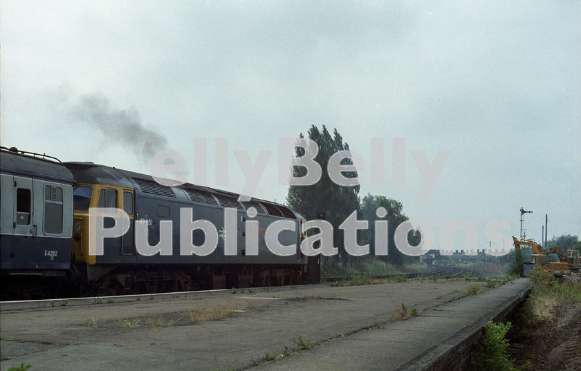 LPAP-DSL-CO-0072 
 47361 'Wilton Endeavour' heads out of West with a holiday extra, as March's West Signal box is demolished, 21st July 1984. 
 Keywords: BR, Eastern, LNER, Cambridgeshire, March, Diesel, BR, Passenger, Colour, Class47, 47361, D1880, TE, 1984